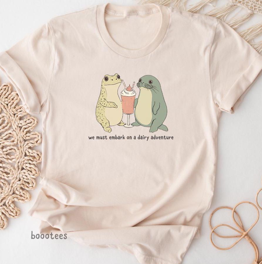 A Frog and Seal Drinking a Milkshake Shirt Ice Cream Funny Cute Gift Lover T shirt Tshirt Tee Tees Meme We Must Embark on a Dairy Adventure Graphic Tee – Warm & Stylish · Top Pick For Any Outfit