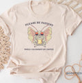 Please Be Patient While I Slurmmpp My Coffee Shirt Funny Cute Cryptid Gift Idea Fantasy Book Lover T shirt Tshirt Tee Tees Meme Moth Man Graphic Tee – Easygoing Wear · High-Quality Print